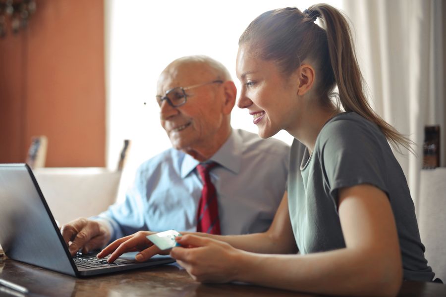 Caregiver helping a senior man at home